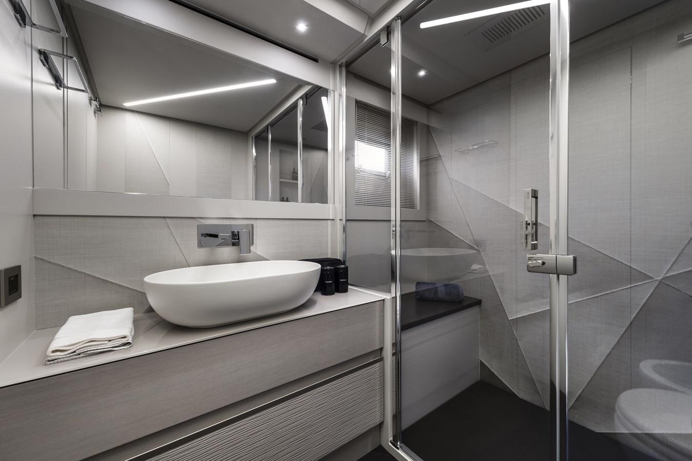 a bathroom with a sink and a mirror aboard PERSHING 7X Yacht for Sale