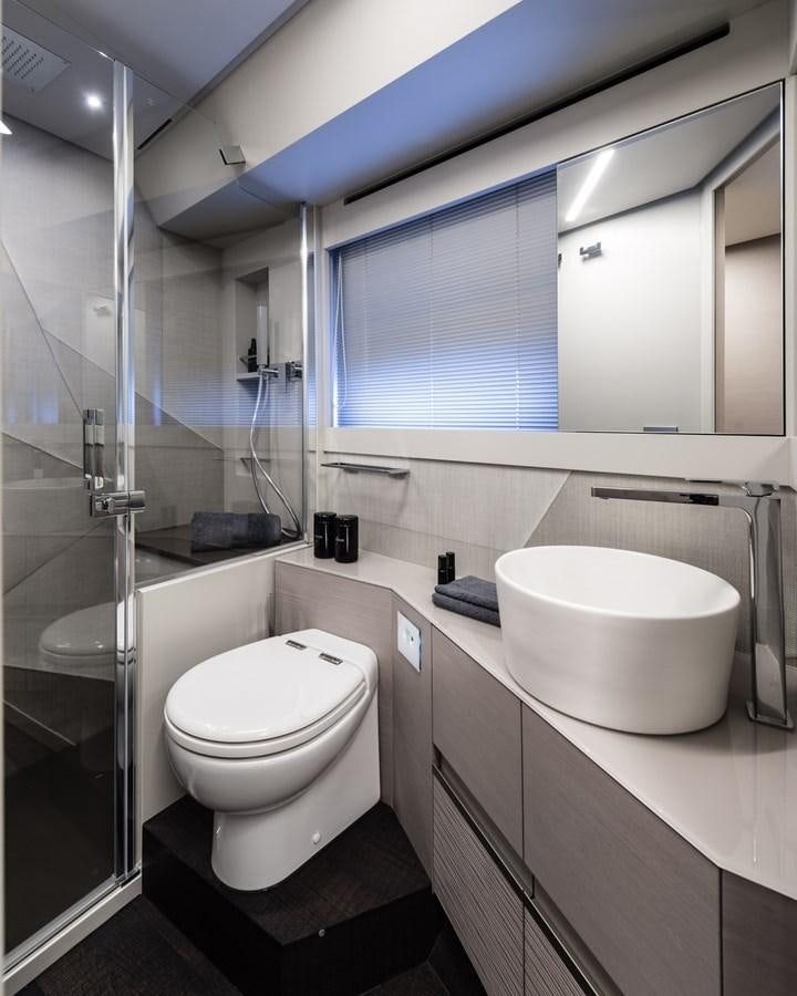 a bathroom with a glass shower aboard PERSHING 7X Yacht for Sale