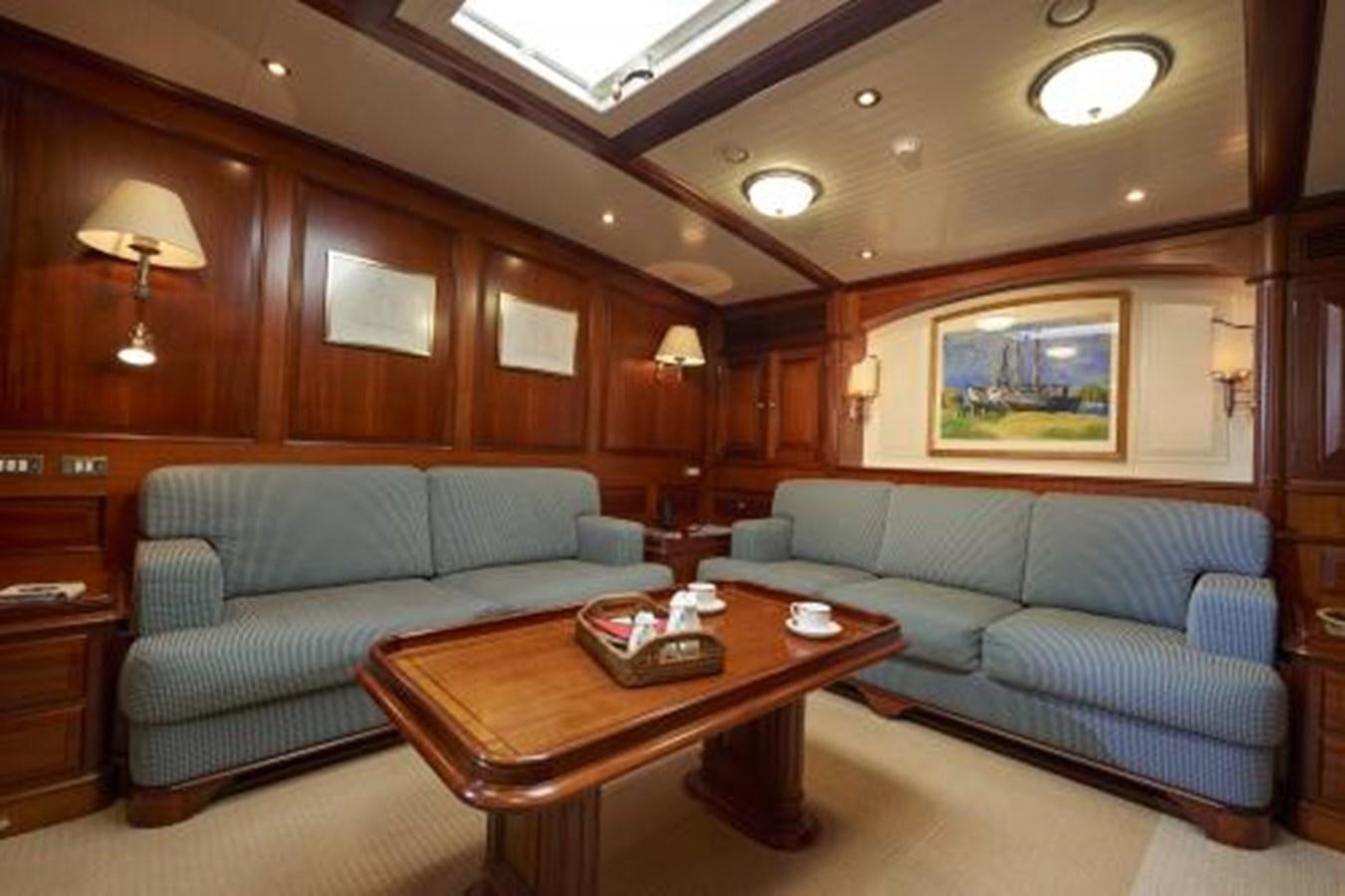 a living room with a couch and a coffee table aboard BORKUMRIFF IV Yacht for Sale