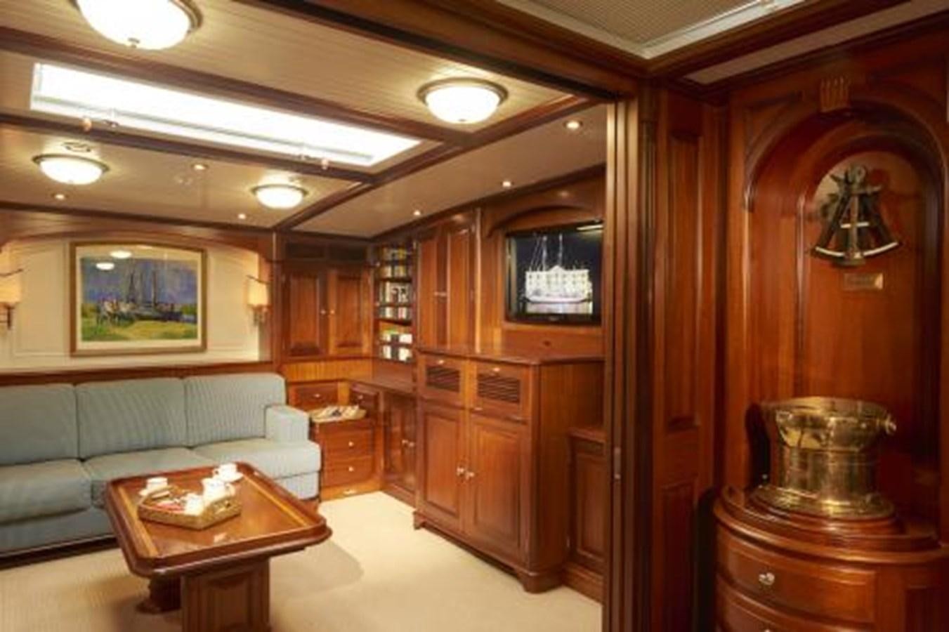 a living room with a couch and a television aboard BORKUMRIFF IV Yacht for Sale