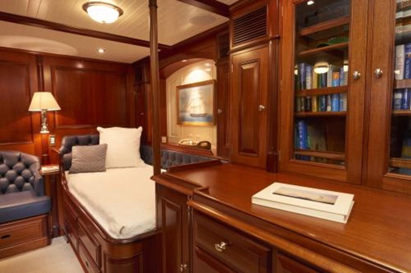 a bedroom with a bed and desk aboard BORKUMRIFF IV Yacht for Sale