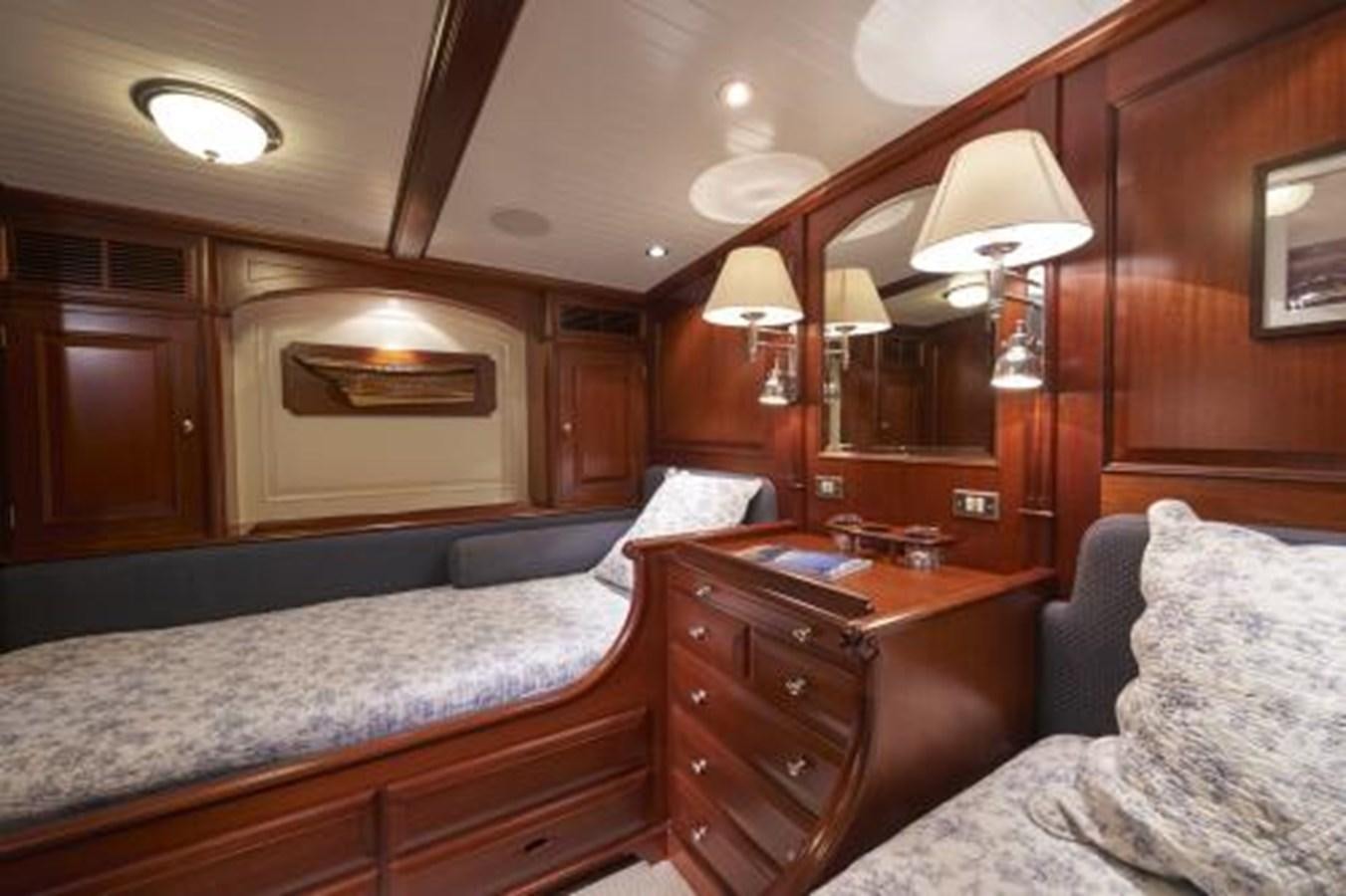 a bedroom with a bed and a desk aboard BORKUMRIFF IV Yacht for Sale