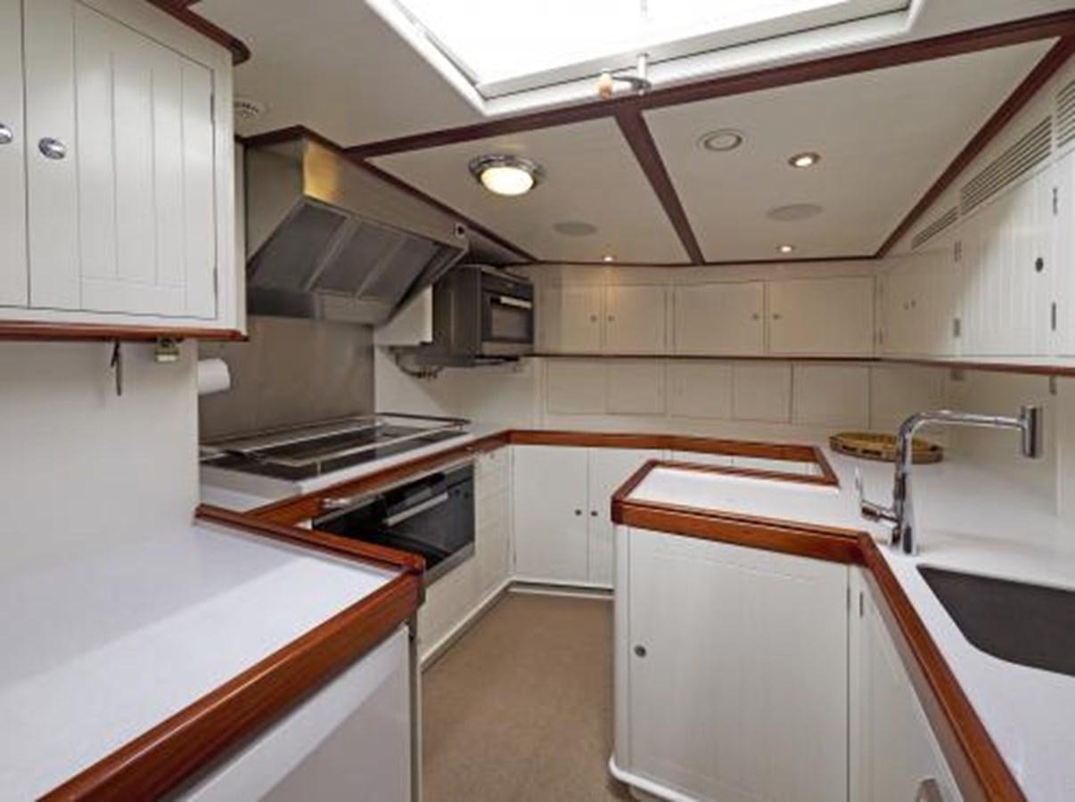a kitchen with white cabinets aboard BORKUMRIFF IV Yacht for Sale