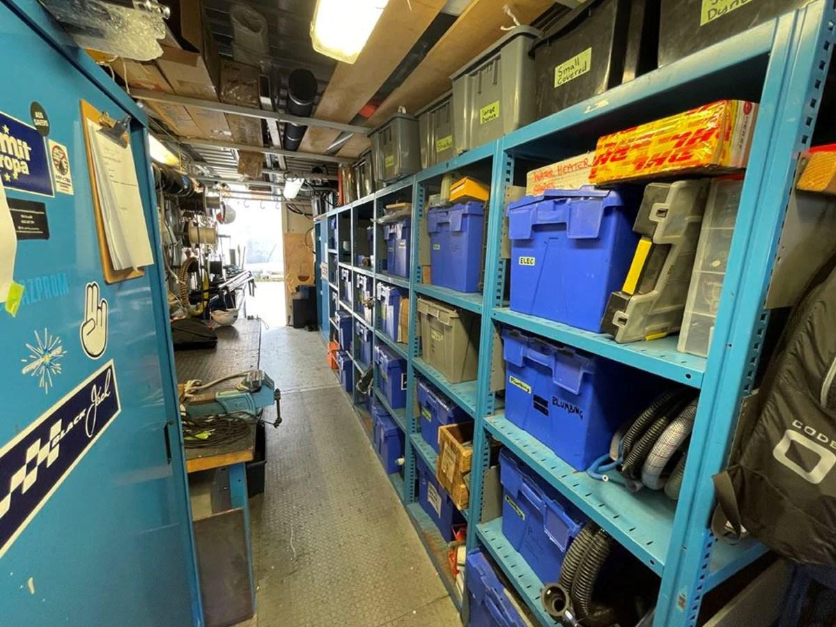 a room with shelves and blue walls aboard BLACK JACK IV Yacht for Sale