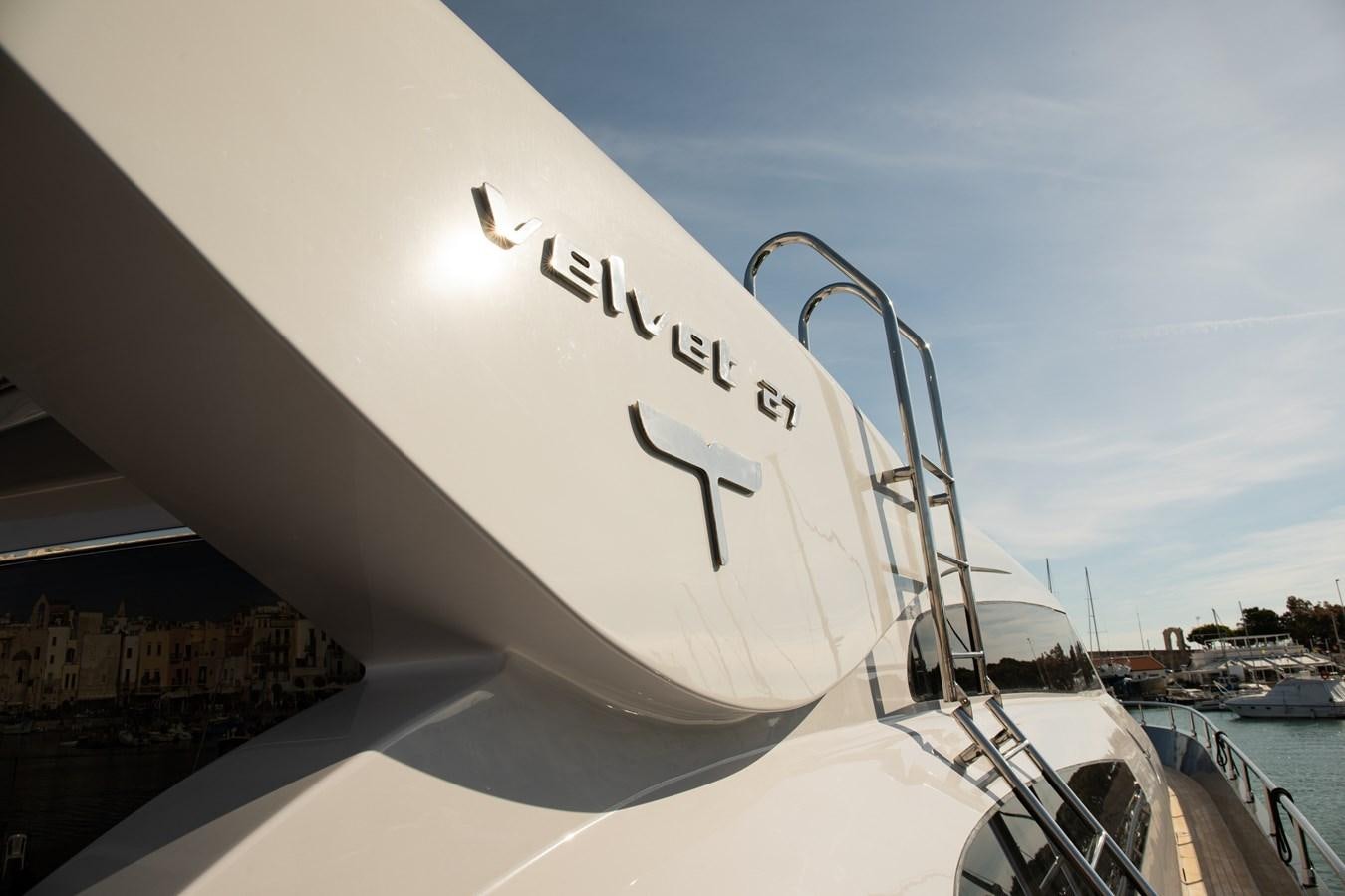 a white airplane with a logo on the side aboard VEVEKOS Yacht for Sale