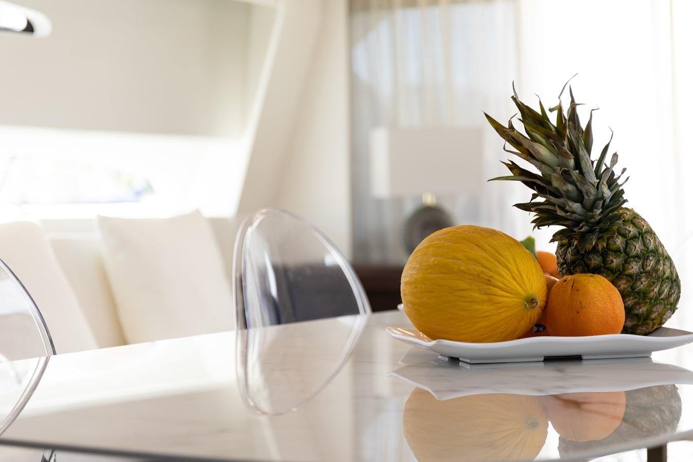 a pineapple on a plate aboard VEVEKOS Yacht for Sale