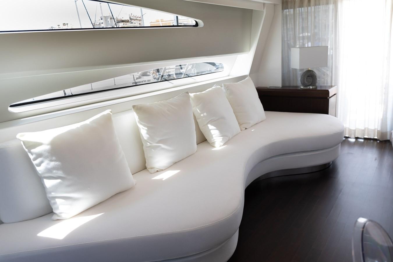 a white couch with white pillows aboard VEVEKOS Yacht for Sale