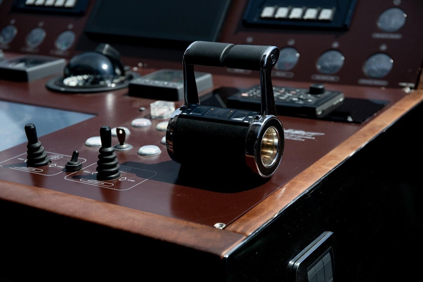 a black and silver camera on a wooden surface aboard VEVEKOS Yacht for Sale