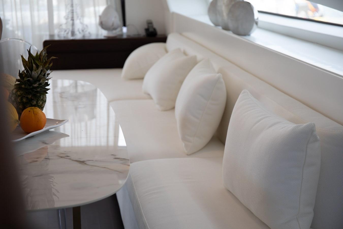 a white bed with pillows aboard VEVEKOS Yacht for Sale