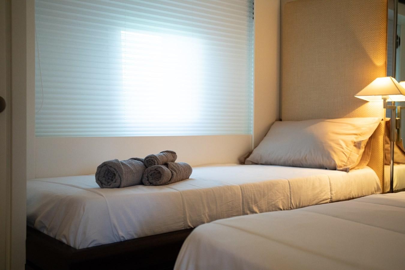 a bed with a white sheet aboard VEVEKOS Yacht for Sale