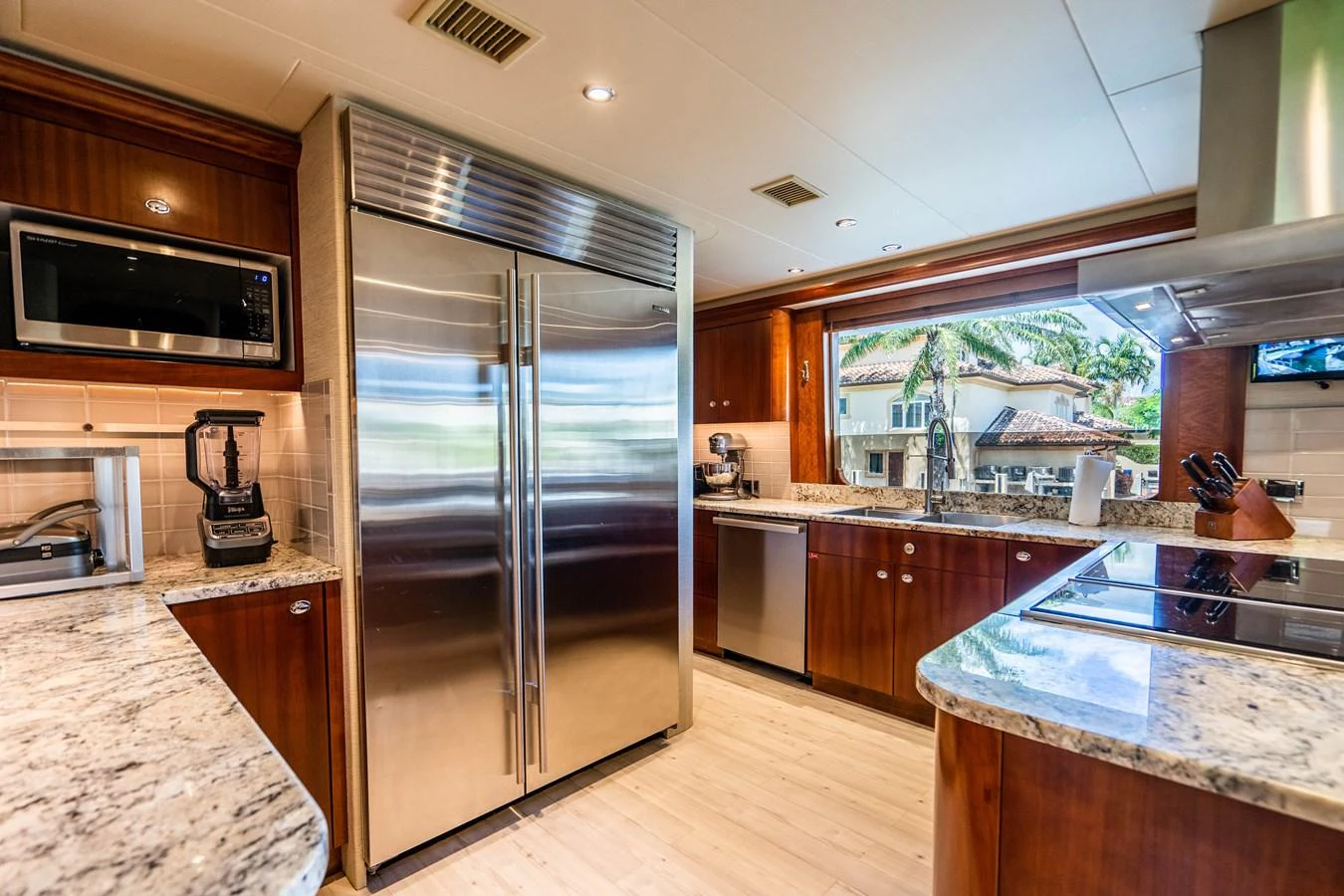 a kitchen with a stainless steel refrigerator aboard SEAQUEST Yacht for Sale