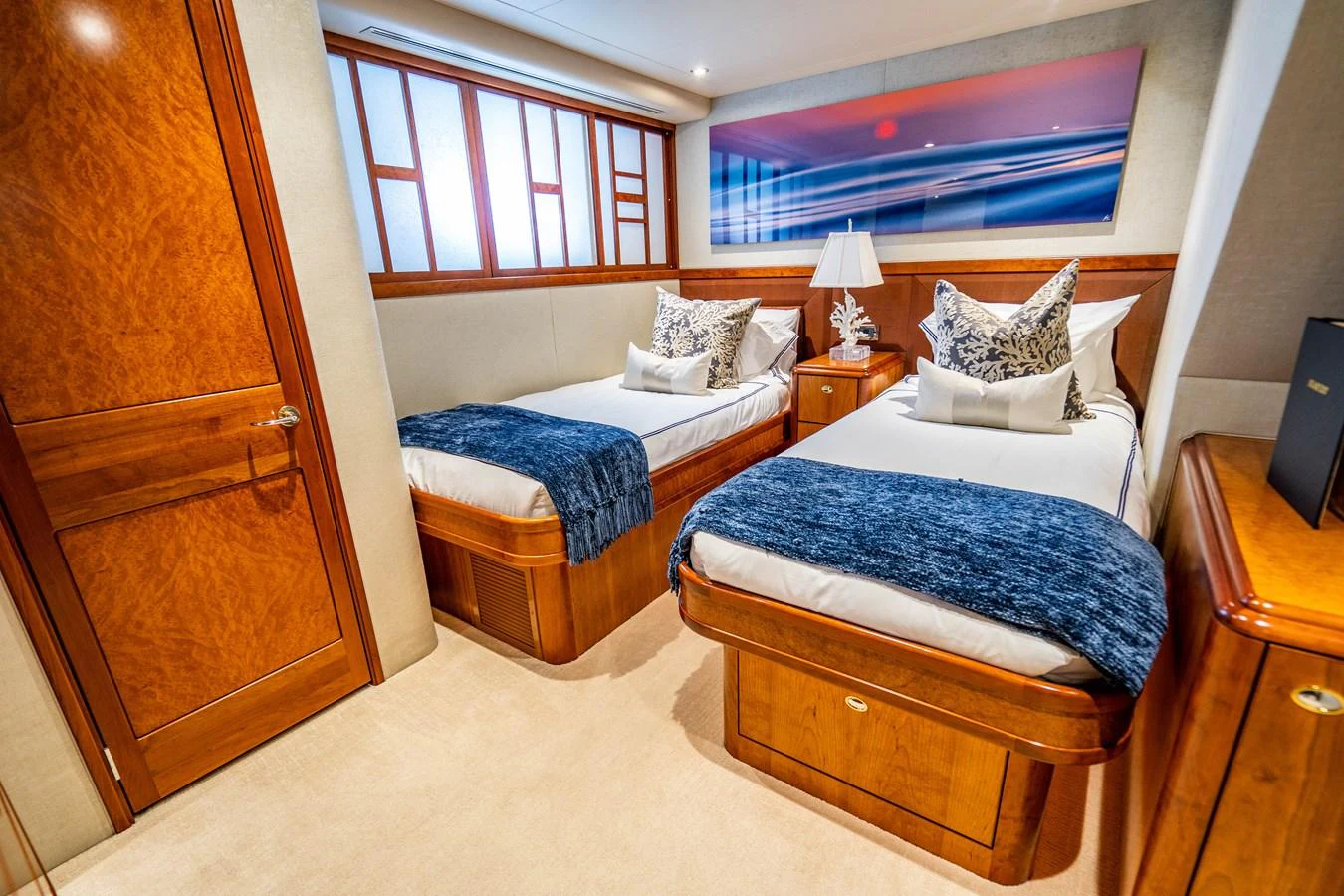 a room with beds and a tv aboard SEAQUEST Yacht for Sale