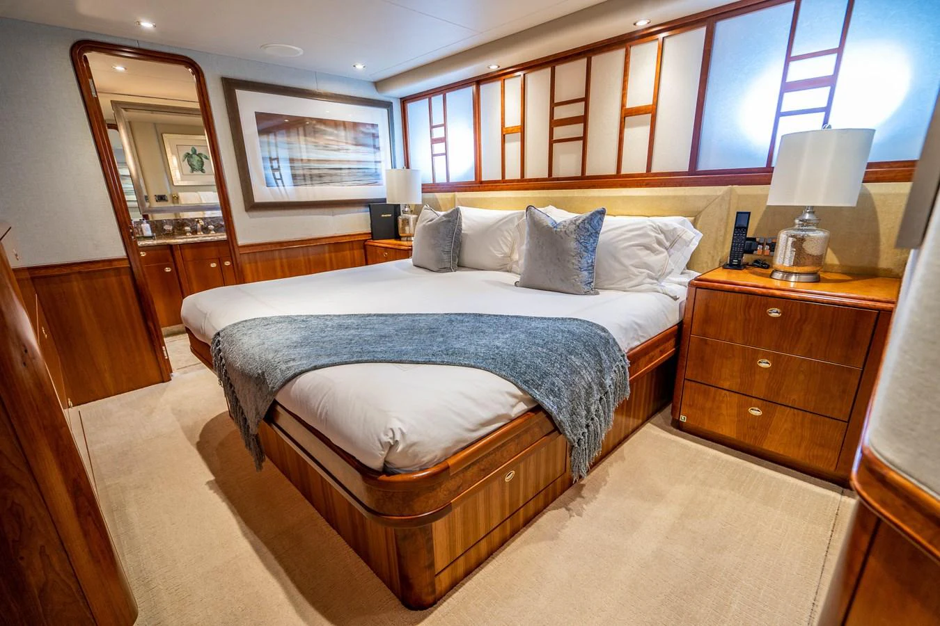 a bedroom with a bed and a desk aboard SEAQUEST Yacht for Sale