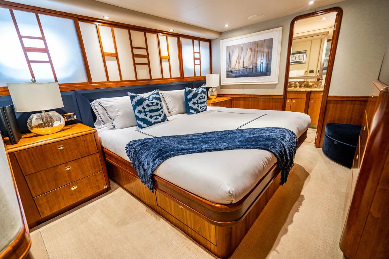 a bedroom with a bed and a dresser aboard SEAQUEST Yacht for Sale