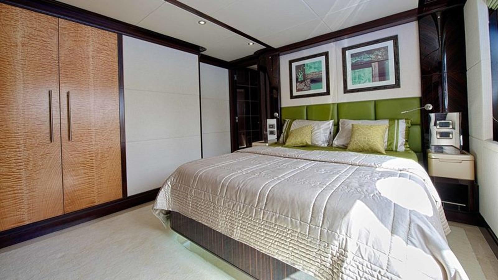 a bedroom with a bed and a closet aboard OCTOBER Yacht for Sale