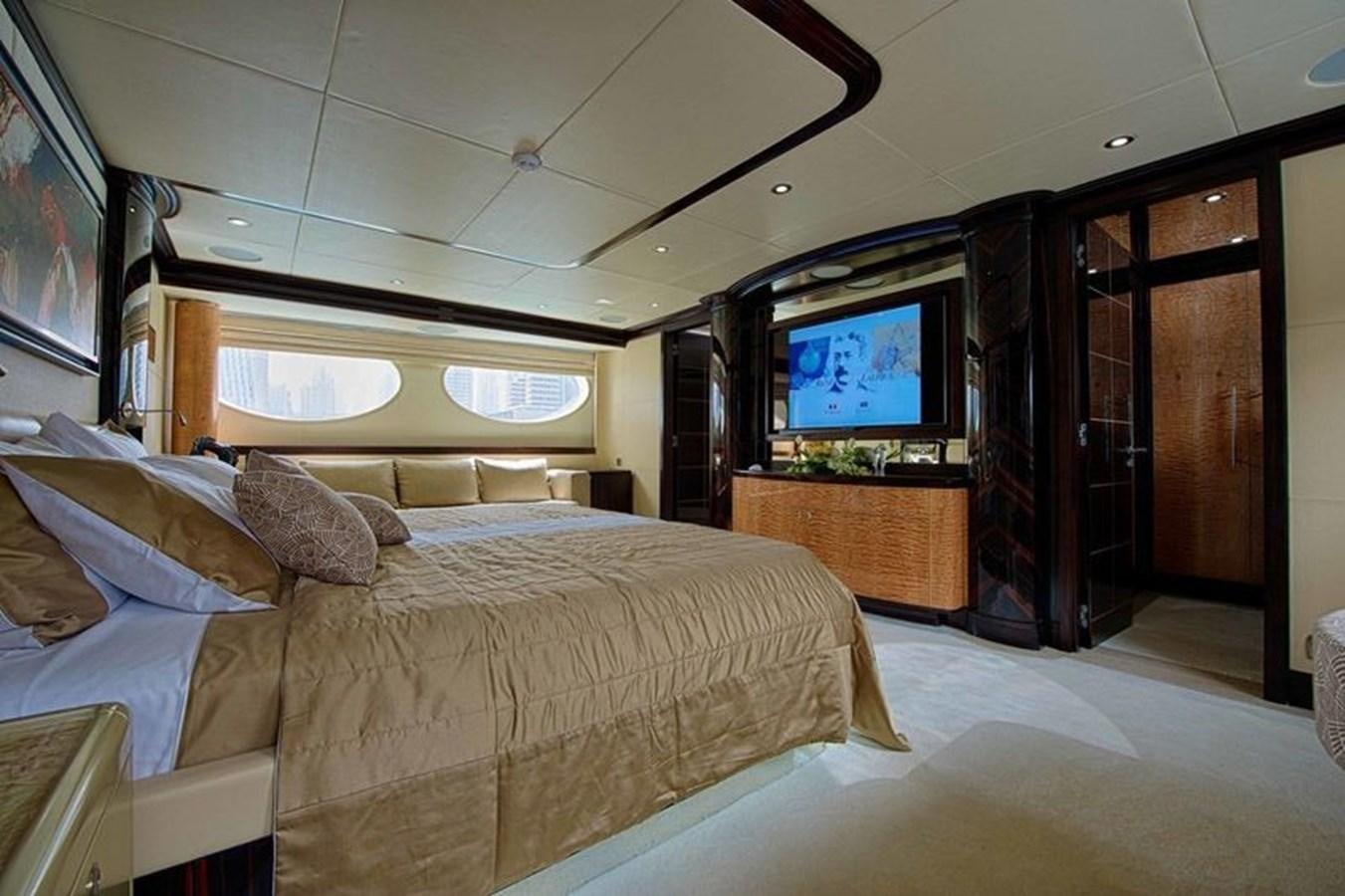 a bedroom with a bed and a tv aboard OCTOBER Yacht for Sale