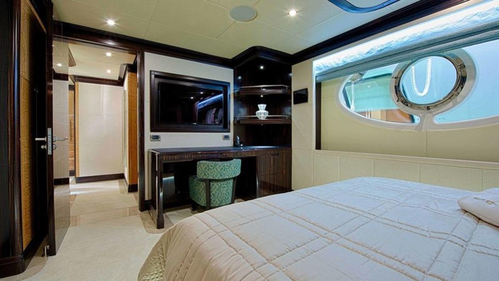 a hotel room with a bed and a television aboard OCTOBER Yacht for Sale