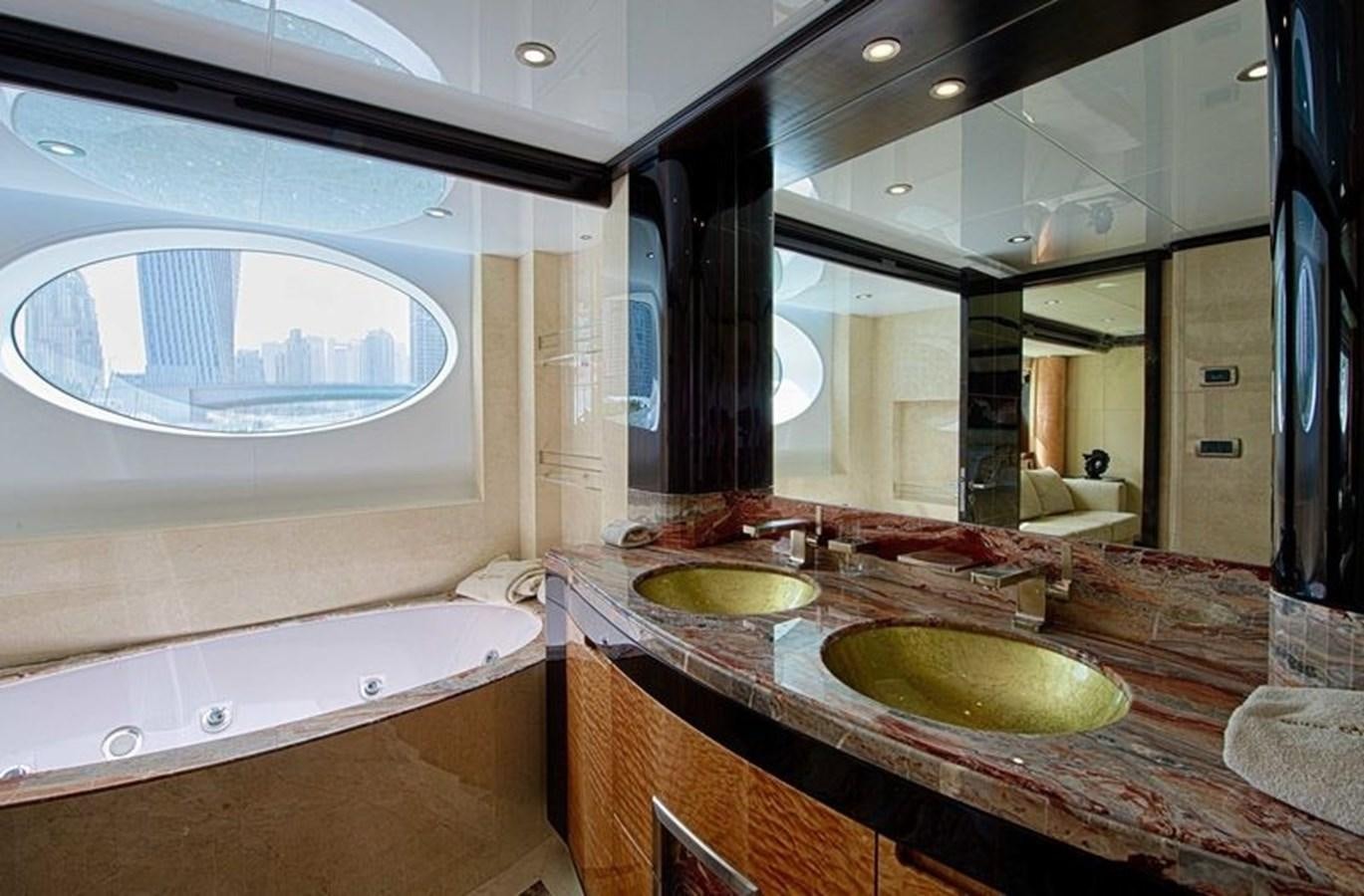 a bathroom with a sink and a large mirror aboard OCTOBER Yacht for Sale