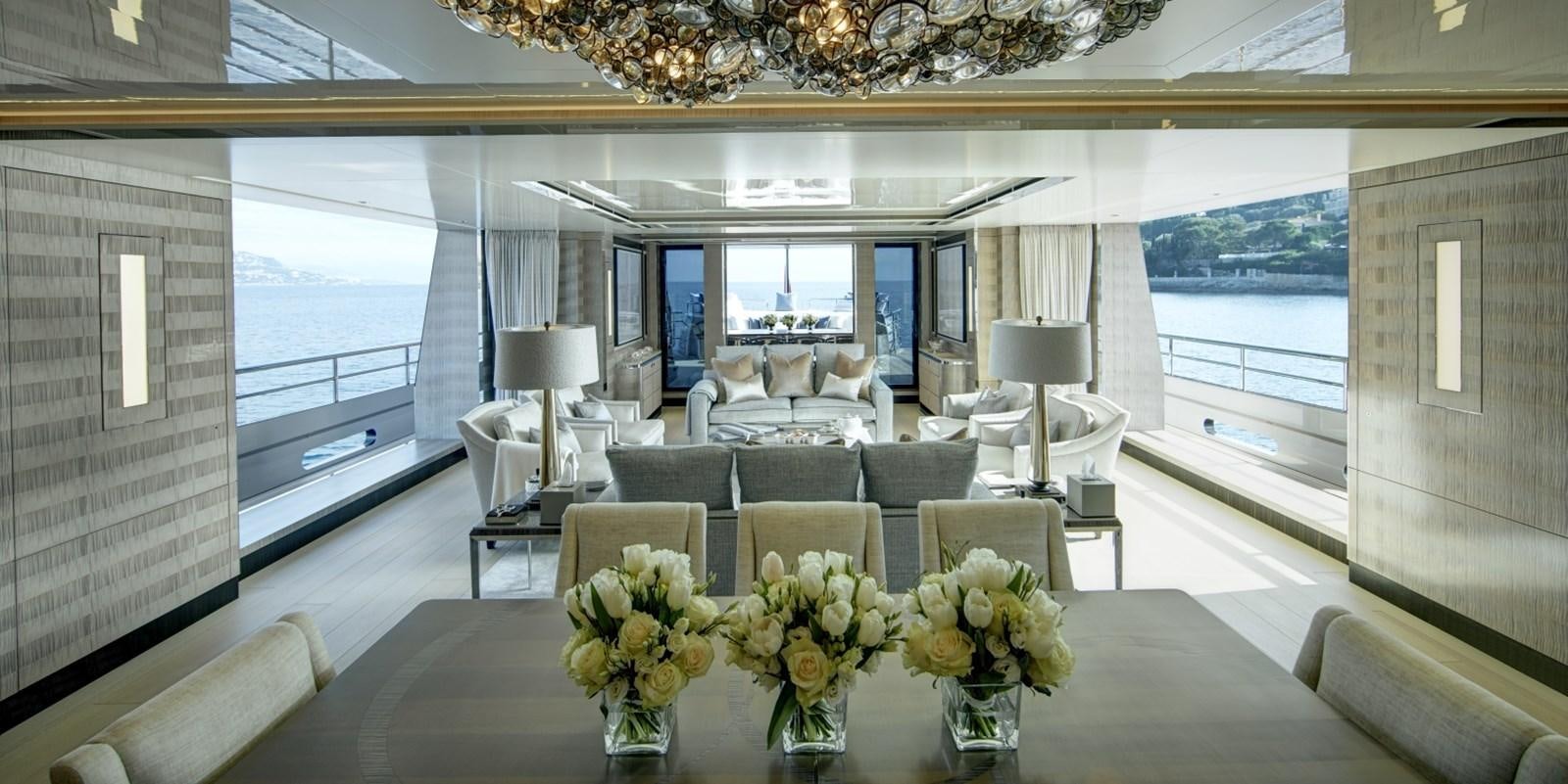 a room with a table chairs and flowers in it aboard LADY VICTORIA Yacht for Sale