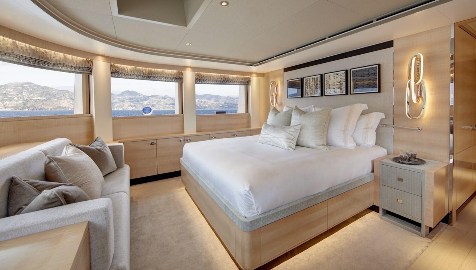 a bedroom with a bed and a couch aboard LADY VICTORIA Yacht for Sale