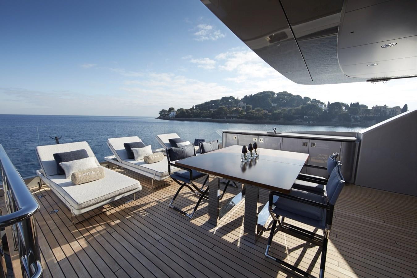 a deck with a table and chairs on it aboard LADY VICTORIA Yacht for Sale