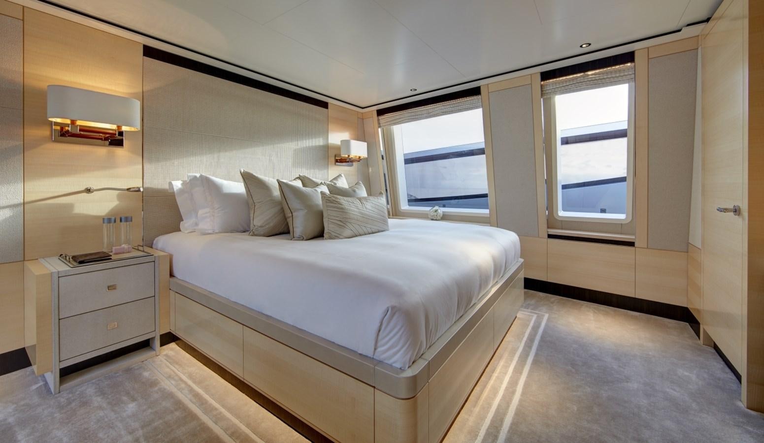 a bedroom with a bed and a window aboard LADY VICTORIA Yacht for Sale
