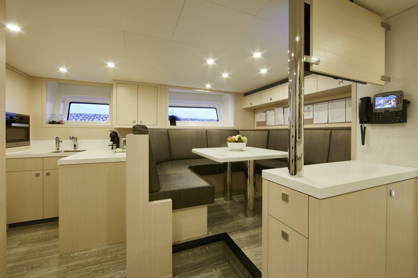 a kitchen with a couch and a table aboard LADY VICTORIA Yacht for Sale
