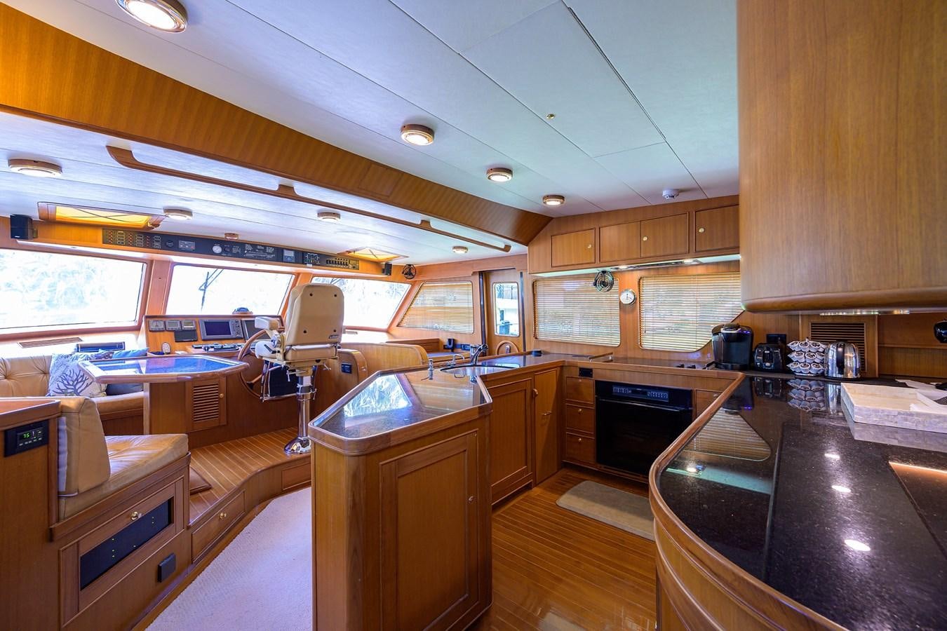 a kitchen with wooden cabinets aboard BELLA Yacht for Sale