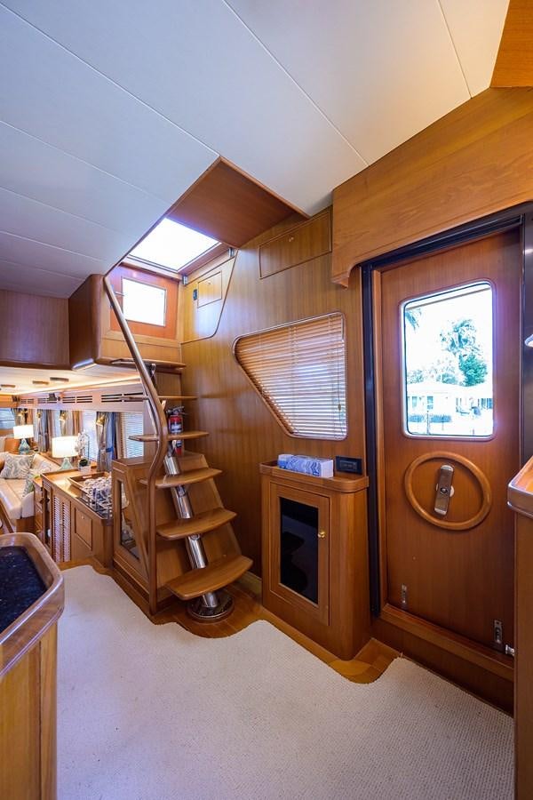 a room with a wood shelf and a bookcase aboard BELLA Yacht for Sale