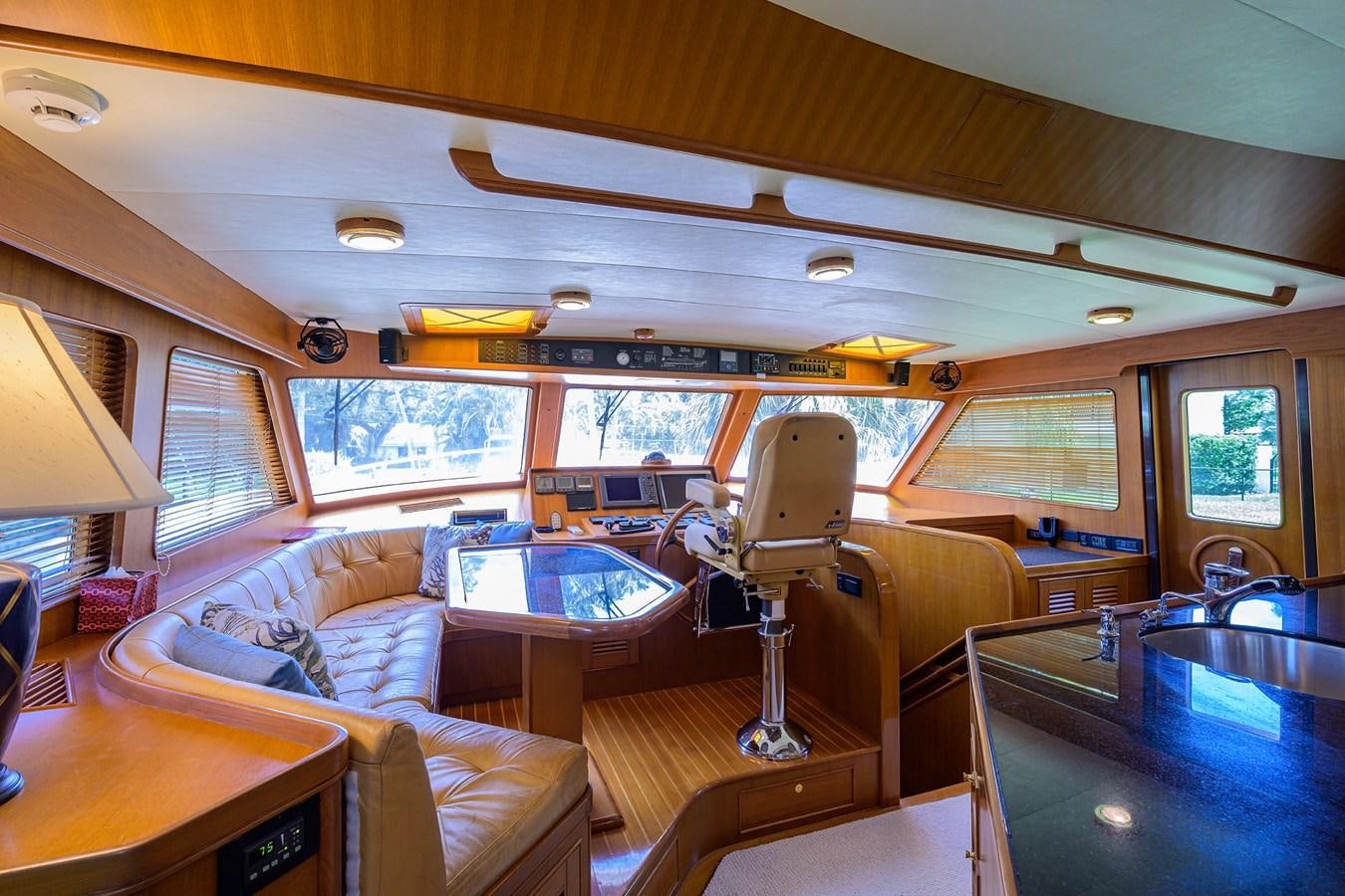 inside of a vehicle with a table and chairs and a lamp aboard BELLA Yacht for Sale