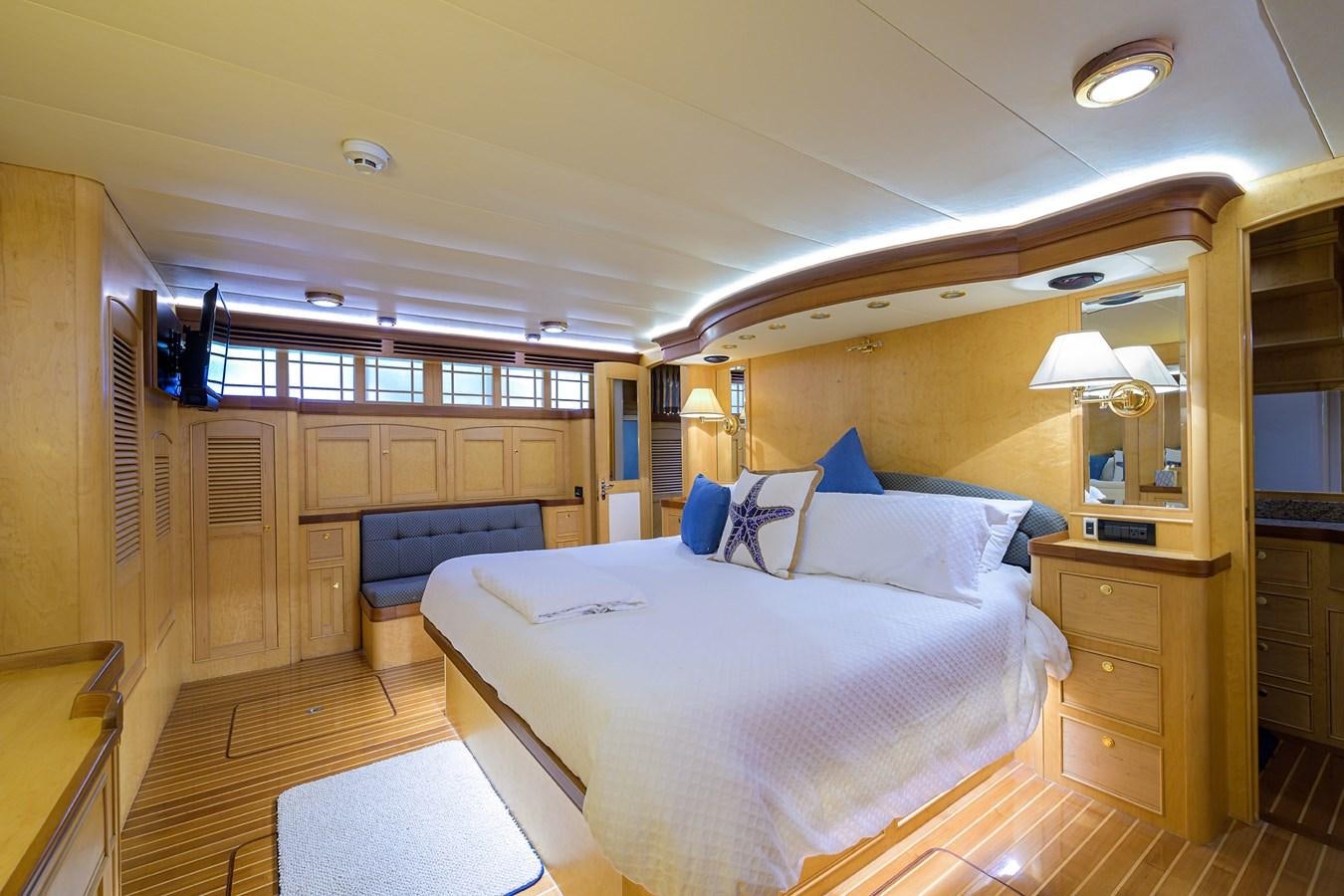 a large bedroom with a large bed aboard BELLA Yacht for Sale