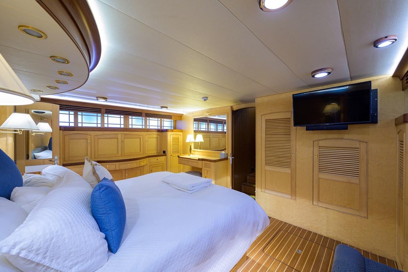 a room with a bed and a television aboard BELLA Yacht for Sale