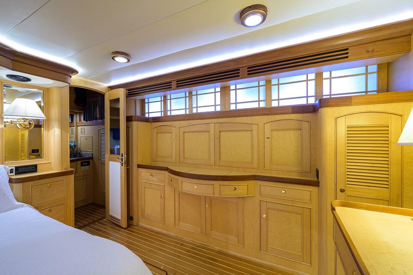 a room with a bed and cabinets aboard BELLA Yacht for Sale