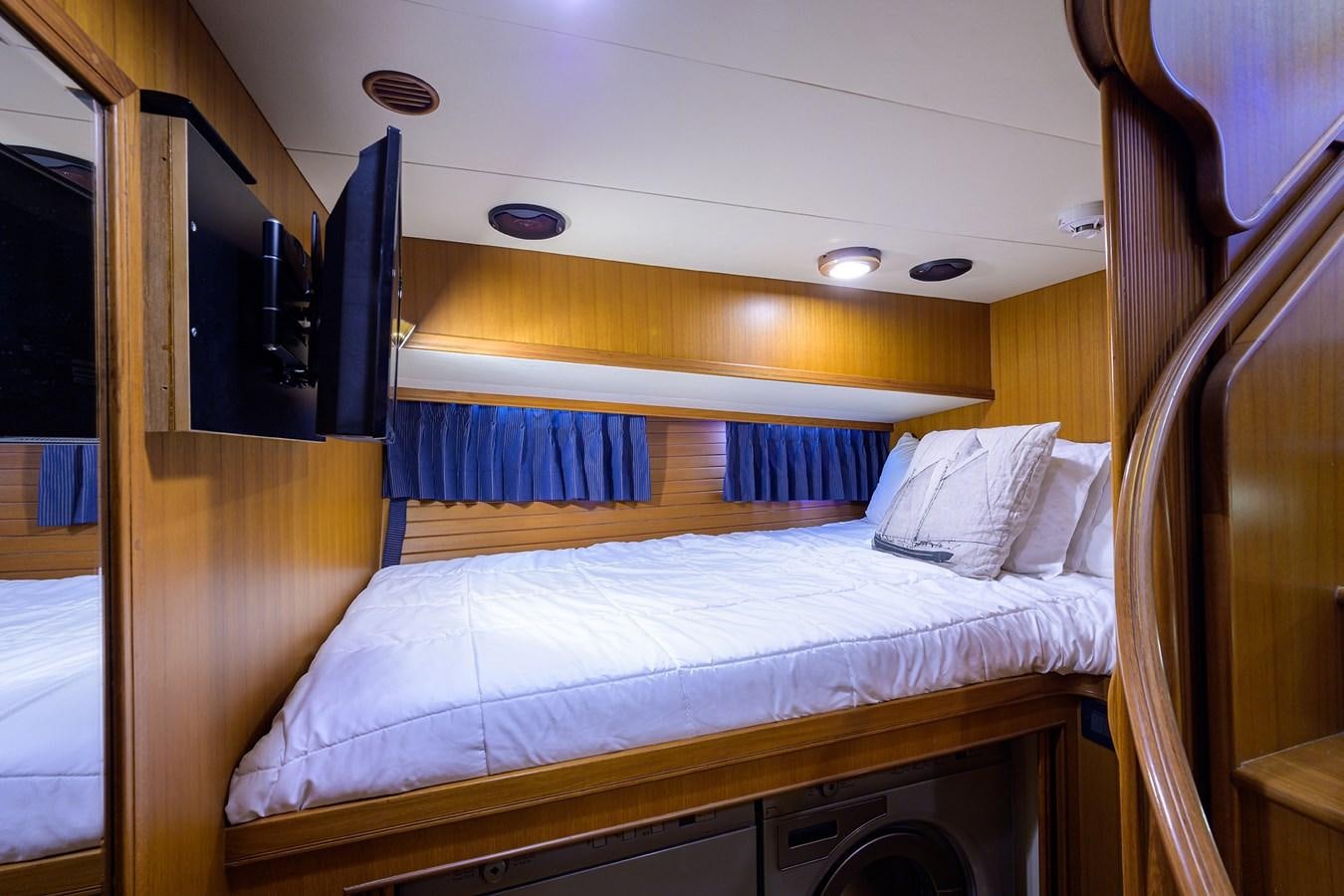 a bed with a wood headboard aboard BELLA Yacht for Sale