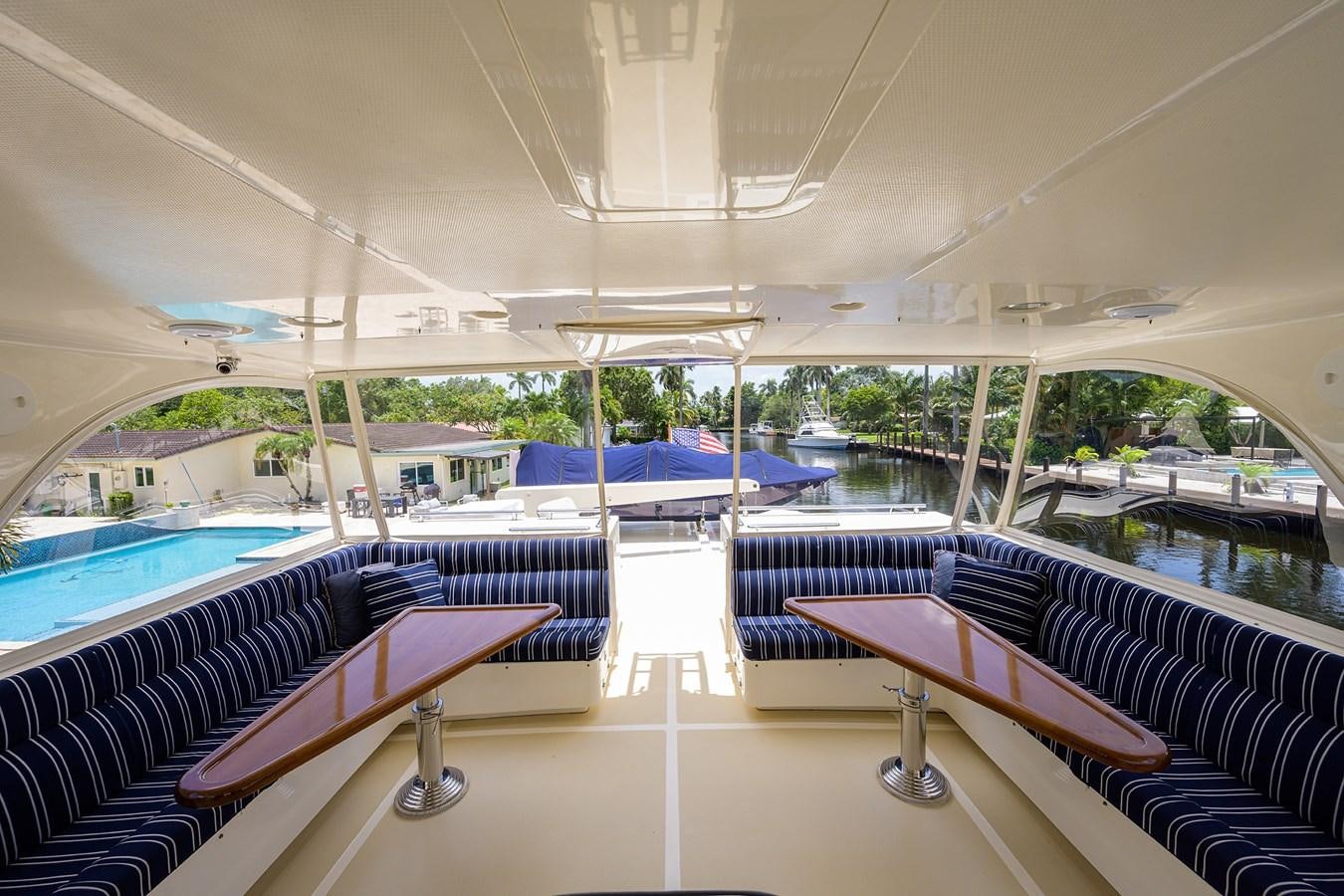 a pool with a deck and lounge chairs aboard BELLA Yacht for Sale