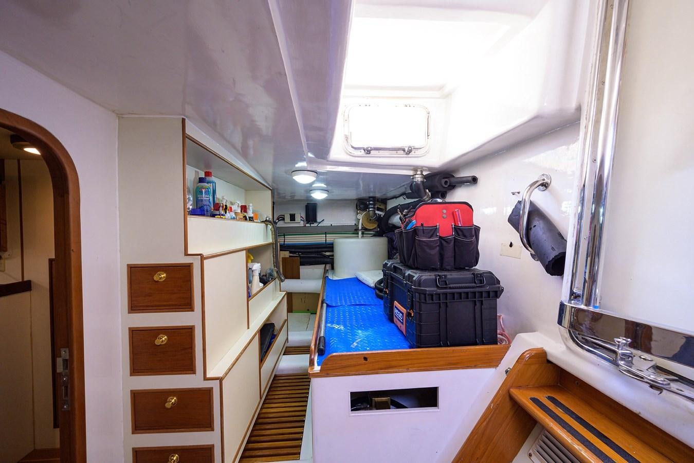 a room with a desk and a shelf with objects on it aboard BELLA Yacht for Sale