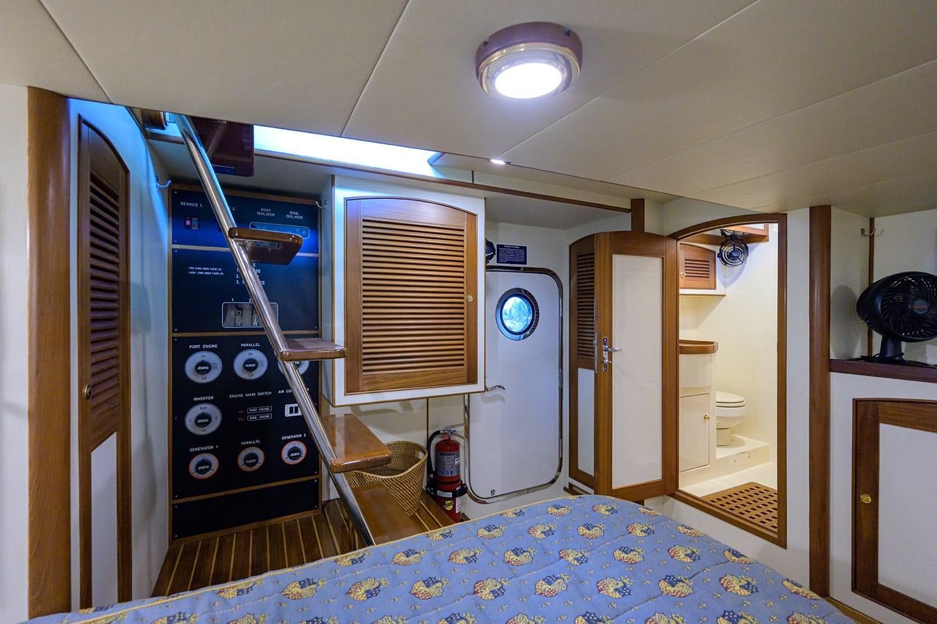 a room with a machine and a bed aboard BELLA Yacht for Sale