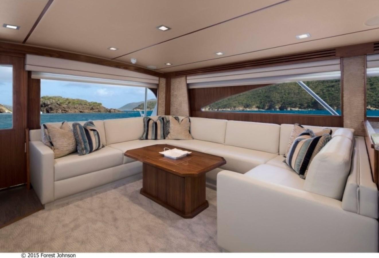 a living room with a couch and a table aboard NEW VIKING 80 ENCLOSED BRIDGE Yacht for Sale