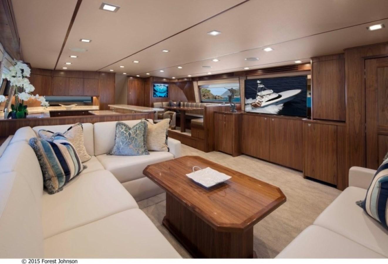 a living room with a couch and a coffee table aboard NEW VIKING 80 ENCLOSED BRIDGE Yacht for Sale