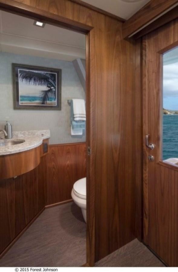 a bathroom with a sink and a toilet aboard NEW VIKING 80 ENCLOSED BRIDGE Yacht for Sale