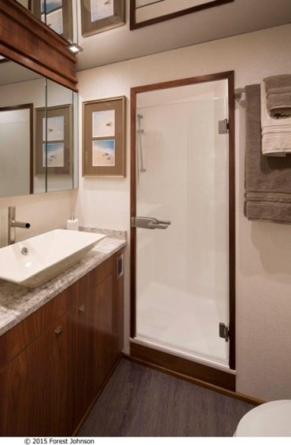 a bathroom with a sink and a shower aboard NEW VIKING 80 ENCLOSED BRIDGE Yacht for Sale