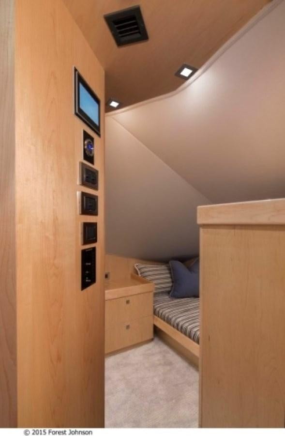 a bedroom with a bed and a tv on the wall aboard NEW VIKING 80 ENCLOSED BRIDGE Yacht for Sale