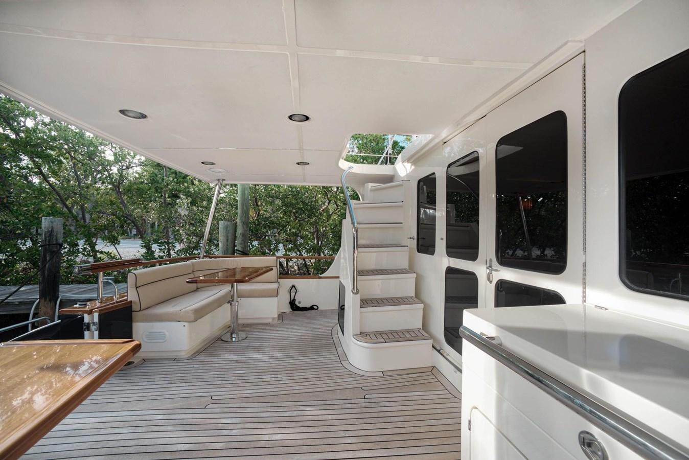 a room with a table and a bed aboard BEN'S BARGE Yacht for Sale