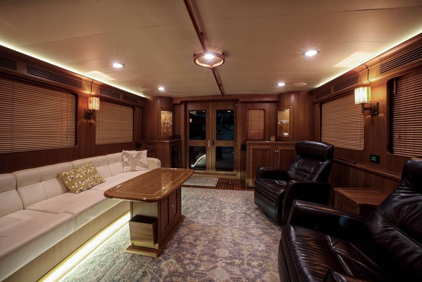 a living room with leather couches and a coffee table aboard BEN'S BARGE Yacht for Sale