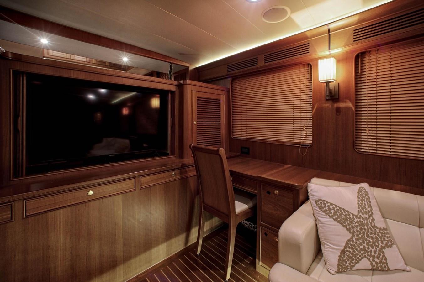 a room with a tv and furniture aboard BEN'S BARGE Yacht for Sale
