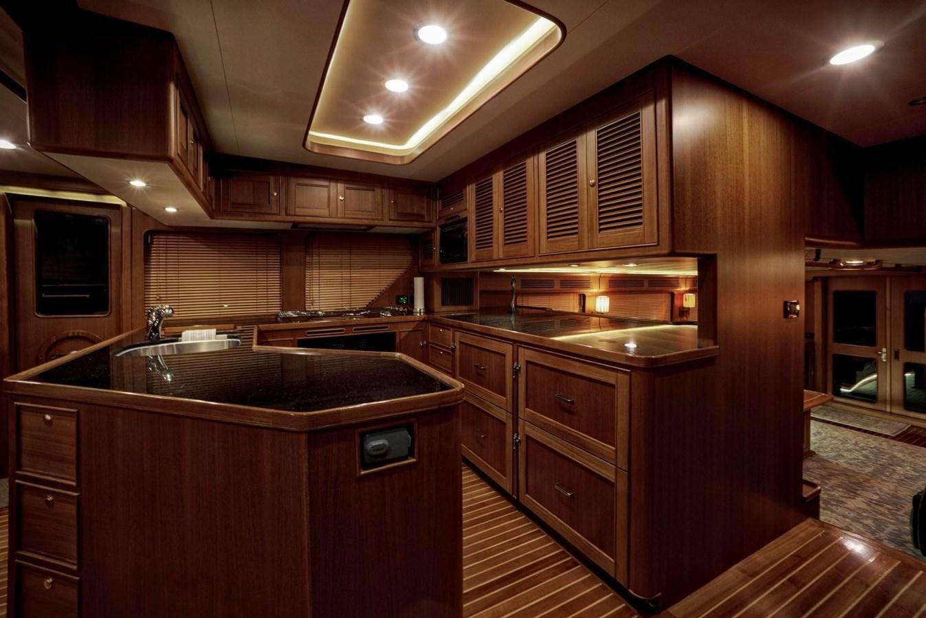a kitchen with wooden cabinets aboard BEN'S BARGE Yacht for Sale