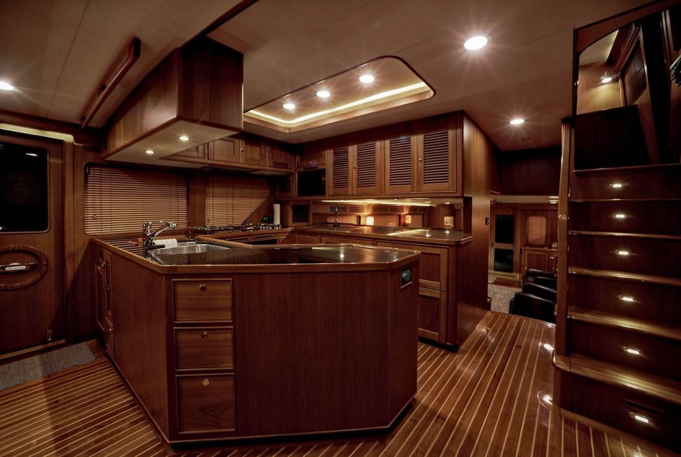 a kitchen with wooden cabinets aboard BEN'S BARGE Yacht for Sale