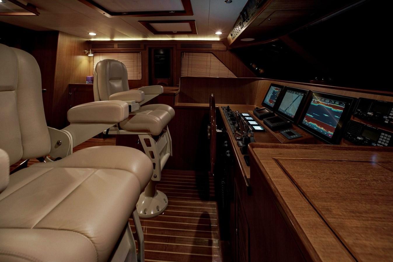 a room with a row of seats and a table with computers on it aboard BEN'S BARGE Yacht for Sale