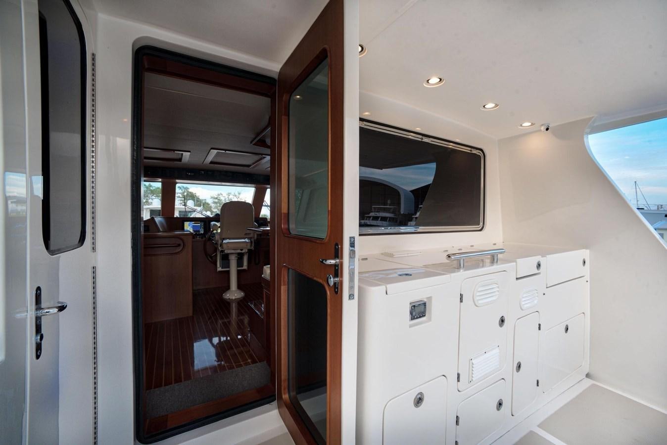 a room with a door and cabinets aboard BEN'S BARGE Yacht for Sale