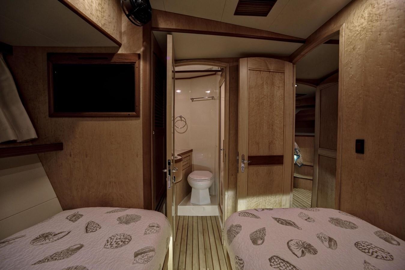 a bathroom with a bed and a mirror aboard BEN'S BARGE Yacht for Sale